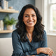 A professional portrait of a happy South Asian woman smiling, representing a satisfied customer testimonial.